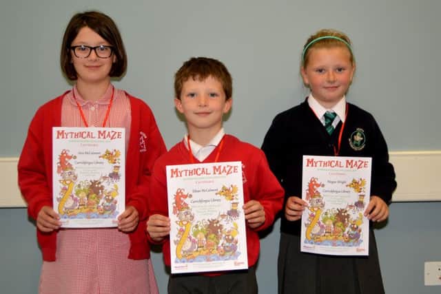 Alex, Ethan and Megan receiving their Summer Reading Challenge certificate at Carrickfergus Library. INCT 36-157-GR