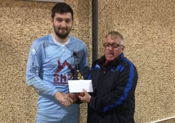 Darren McFadden picks up his man of the match award after his display against Strabane Athletic.
