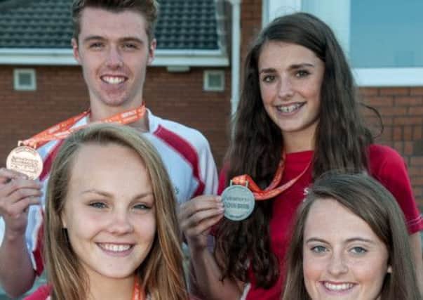 Lurgan Ladies' Hockey Club's Kathryn Edgar and Alex Hurst (front row, from left) with Zach McClelland (Portadown) and Alana Doyle (Armagh) following success at the Sainsbury's School Games. Zoe Jackson, another Portadown player, was unavailable for the photograph. Pic by Lionel Mitchell.INPT3714-412