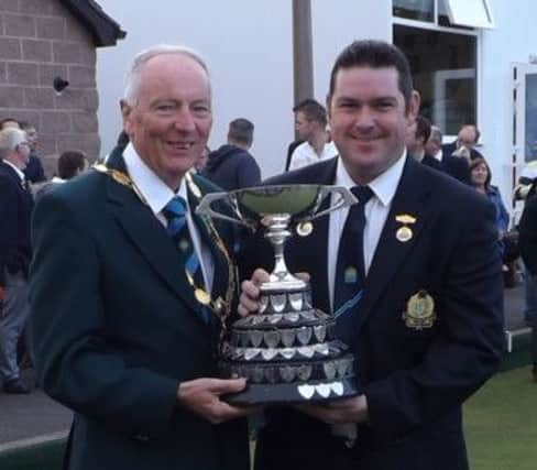IBA President, Erroll Whitten, hands over the Cup to the new Irish Open Singles Champion Neil Mulholland (Lisnagarvey).