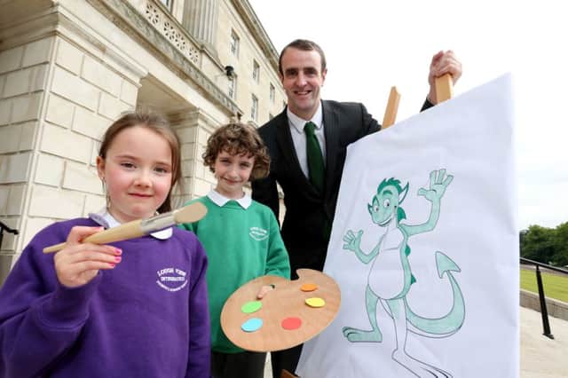 Helping Environment Minister Mark H. Durkan launch the Belfast Harbour Green Teacher of the Year Award, which will have an arts theme for the final challenge day, are Tiarnan Lyons and Rebecca Walker, P3 pupils at Loughview Integrated Primary School.