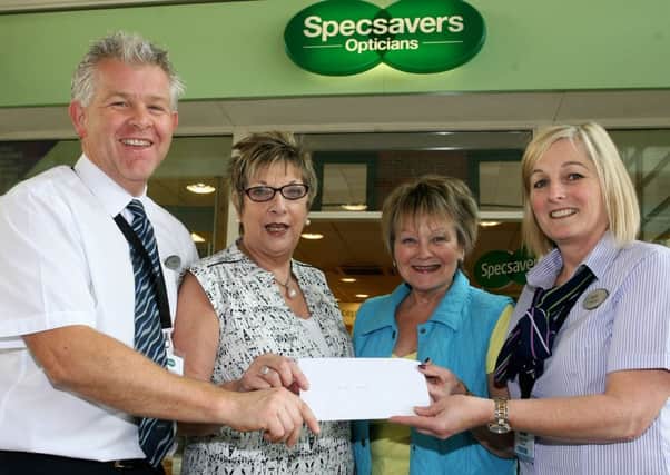 Adrian Murdoch and Jacqui Dougles of Specsavers are pictured presenting a cheque for £630 to Jennifer Winning and June Cherry of Guide Dogs for the Blind. The money was raised by Adrian who completed a 83 mile charity cycle. INBT38-204AC
