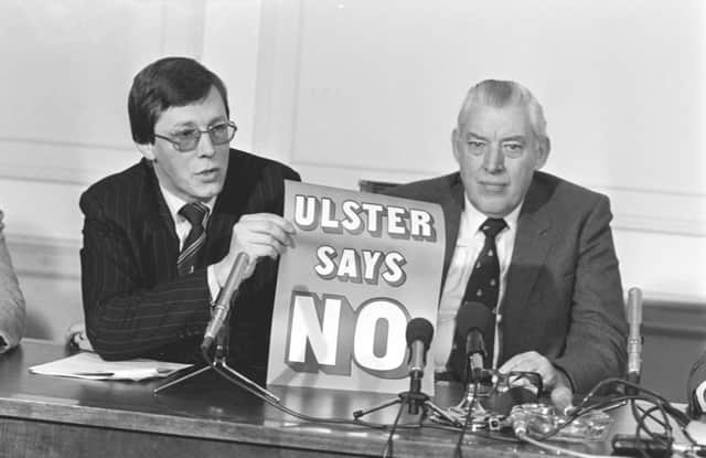 Rev Ian Paisley and his then DUP deputy leader Peter Robinson at a 1985 press conference with their 'Ulster Says No' poster