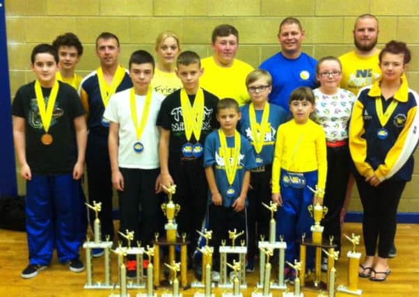 Jan Ling club members with the trophies they won at the Northern Ireland Open Martial Arts Championships hosted by the club in Ballymena recently.