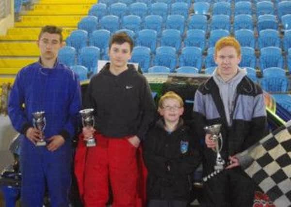 Ballymena's Aaron Moody receives the Junior Rod Champion of Champions Trophy from Raceway mascot Thomas Kirk. Also in shot are Patrick O'Boyle and Liam Wilson (left).