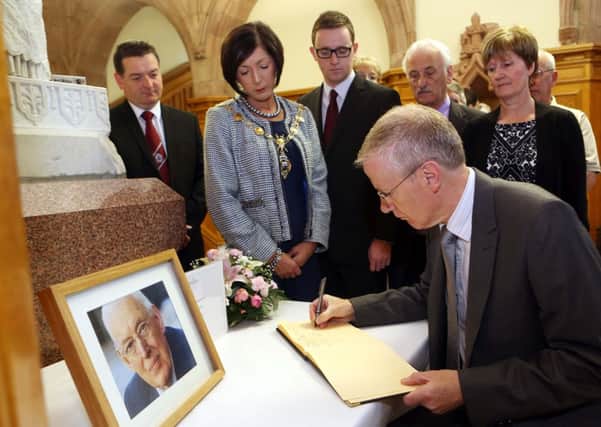 MP Gregory Campbell signs a book of condolence for Lord Bannside