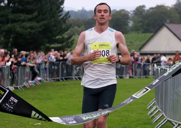 Gary Murray, St. Malachys AC, crosses the line to take first place in the Waterside Half Marathon.  3714-9510MT.