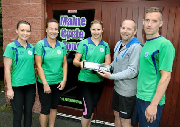 Ballymena Hockey Club members Vicky Hogg, Grace McBurney, Joanne Fulton and Tim Lowry receive sponsorship balls from Joe Martin from Maine Cycle Zone, Cullybackey. INBT 36-801H