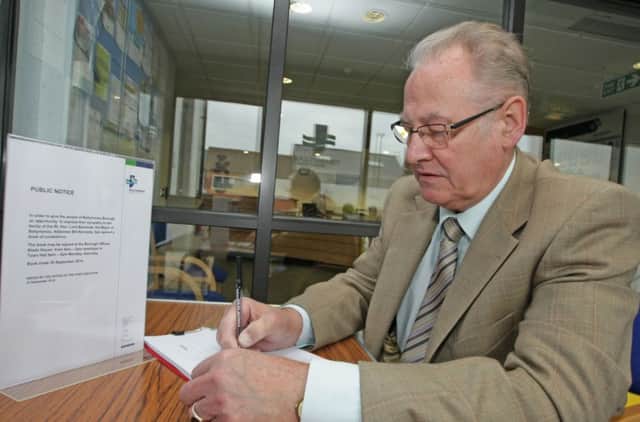 Pictured is Alderman Frank Campbell  (DUP) signing the book at Riada House on Monday.INBM38-14 025SC.