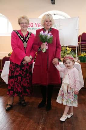 In Hillsborough Courthouse, having been presented with a floral posy at a reception hosted by Lisburn City Council, is HRH the Duchess of Cornwall; the former Mayor of Lisburn, Councillor Margaret Tolerton and little Emma Smith, grand-daughter of the former Mayor who presented the flowers for the Council's Royal Launch of Hillsborough in Bloom 2014.
