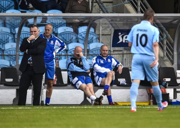 Ballymena United manager Glenn Ferguson watches as captain Allan Jenkins is sent off in the opening minutes of Saturday's game against Glentoran.
 Picture: Russell Pritchard / Presseye