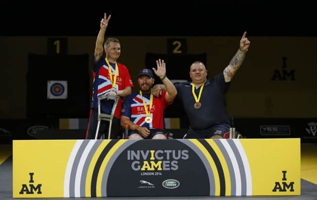 Gary Prout, David Hubber and Steven Gill of Great Britain on the podium after the final of the Recurve Open archery at Olympic Park on September 12, 2014 in London. Photo by Steve Bardens/Getty Images for Invictus Games.