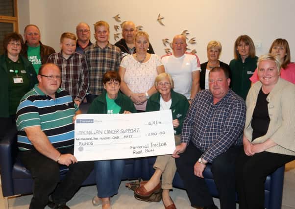 Alastair Brown (left) and Colin Smyth (right) present a cheque for £2350 on behalf of the Memorial Tractor Road Run to Macmillan Ballymena chairperson Margaret Jamison and treasurer Susan McMillan. Included are members who took part in the Memorial Tractor Road Run earlier this year plus Macmillan committee member Pamela Palmer. INBT 39-103JC