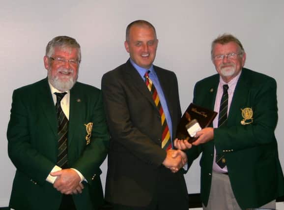 Bernard McCourt presenting the Whitewash Trophy to the victorious LGC Captain Peter Cairns after the annual match with NIAGS, with President Andrew Crawford looking on.