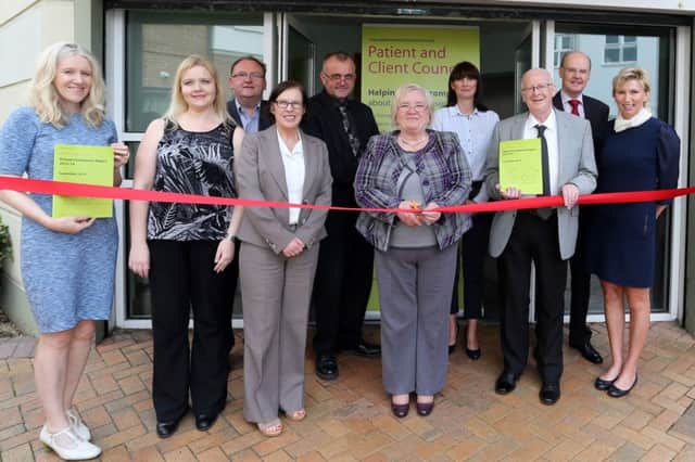 Cllr Beth Adger cuts a ribbon to mark the official opening of the new Patient and Client Council office at Wellington Court last week. Cllr Adgers is joined by Patient and Client Council Chief Executive Maeve Hully, her personal secretary Briege McAlister, John Moore (Northern Trust Local Advisory Committee), Bernie Candlish (Ballymena Borough Council), Richard Dixon (Complaints Services Manager), Emma Andrew (Northern Trust), Cllr Tommy Nicholl, Cllr Declan O'Loan, Jackie McNeill (Involvement Services Programme Manager for the Patient and Client Council). INBT 39-106JC