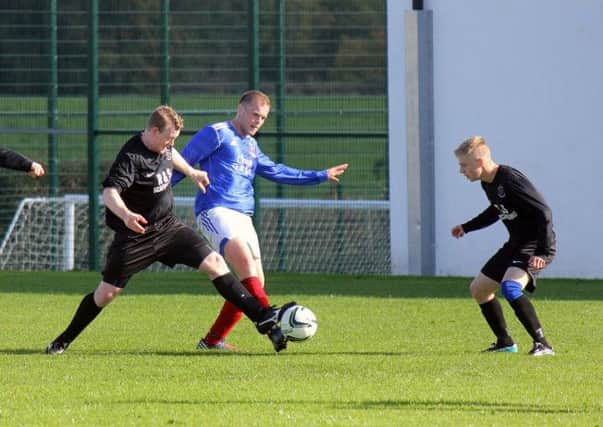 Carniny Rangers and Clough Rangers battle for possession during Saturday's Top Four semi-final at Ahoghill.