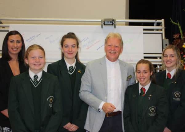 St Cecilia post primary pupils and teacher pictured with Rev David Latimer, as they celebrated the announcement of the new Guinness World Record for 'Most Signatures on a Scroll' at St Mary's College.