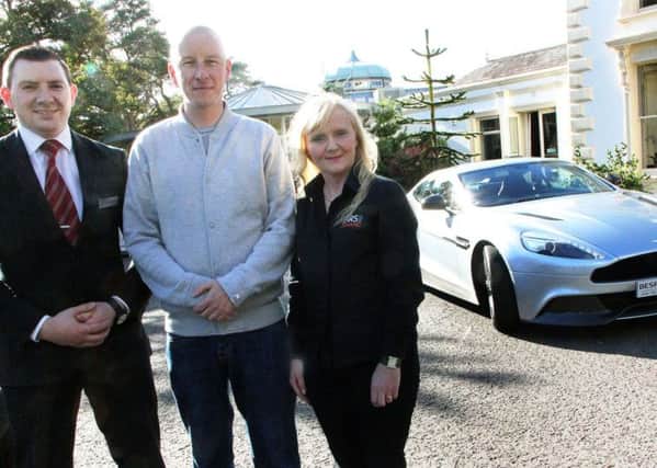 Greg Wallace, who won an outing in an Aston Martin Vanquish in Galgorm Resort and Spa's Fathers' Day draw, is congratulated on Saturday afternoon at Galgorm Resort and Spa by Frankie McDonald, House Manager, and Denise McAuley of Bespoke Auto Group (Ballymoney) before embarking on a motoring experience of a lifetime. INBT 38-920H