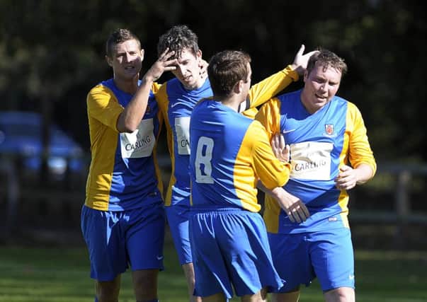 Nortel's Dale Fenner (right) scores to make it 1-1 against Crumlin United in the Border Cup and is congratulated by his team-mates. Photo: Philip McCloy