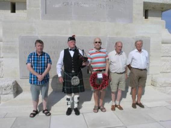 Members pictured with the lone piper at the Helles Memorial.