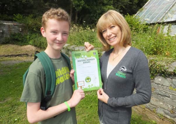 Keen wildlife watcher, Andrew Moore, from Newtownabbey, has achieved a Nature Ranger Award, from Ulster Wildlife, a first for Northern Ireland - for a project which he completed about urban wildlife.  Presenting Andrew with his award is Christine Chambers, from Ulster Wildlife. To find out more about Wildlife Watch, the biggest nature club for kids -  visit www.wildlifewatch.org.uk or www.ulsterwildlife.org. INNT 39-458-CON