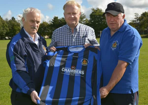 Gordon Chambers, centre, of W&J Chambers Concrete Products, pictured handing over a sponsored soccer strip to Drew Thompson, left, club chairman, and Don Olphert, team manager, BBOB Football Club. NLS3814-117KM