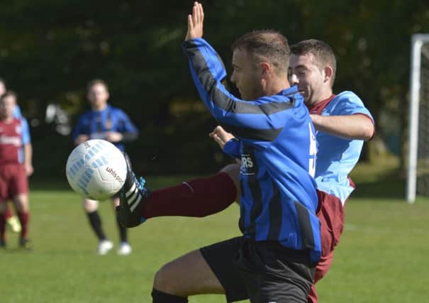 BBOB's Sean Paul Donnelly tussles with St. Mary's Reserves defender Mark O'Connor for the ball. INLS3814-123KM