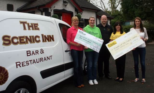 Maria Small, (second left) the regional fund-raiser for Macmillan Cancer Care and Claire Hogarth from Friends of the Cancer Centre in Belfast, pictured receiving cheques for £11,000 from management at the Scenic Inn - Shirley McKinley and Stephen and Pamela McFetridge. inbm40-14 s
