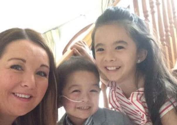 Little Caiden Tang (centre) with his sister Ellie and mum Kathy O'Neill. The family has come on board to share their story in support of Cancer Fund for Children's Childhood Cancer Awareness Month Campaign.