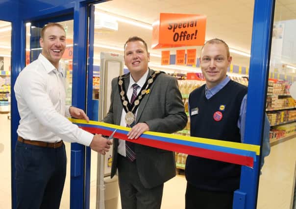 Barry Mc Conville, the new Store Manager of Lidl with former Rugby International Stephen Ferris and Councillor Andrew Ewing, Mayor of Lisburn.