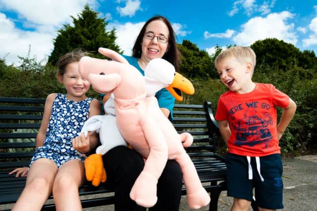 Judith West, Cancer Focus NI cancer prevention officer, holds a puppet show for Heidi and Patrick to encourage them to eat more healthily and get plenty of exercise. inbm40-14s