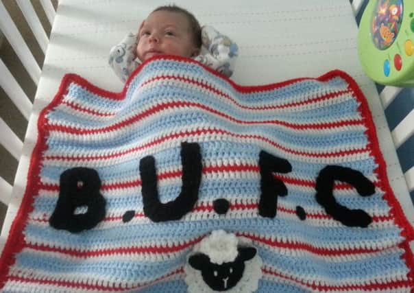 Little Lewis Oliver in his specially-created Ballymena United blanket.