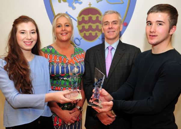 St Pius X College Magherafelt students Laura Cann and Daniel Maguire who were awarded the Principals award for leadership. Looking on are Ms Bartley (Principal) and Brian McErlain (Chair of the Board of Governors).INMM3914-364