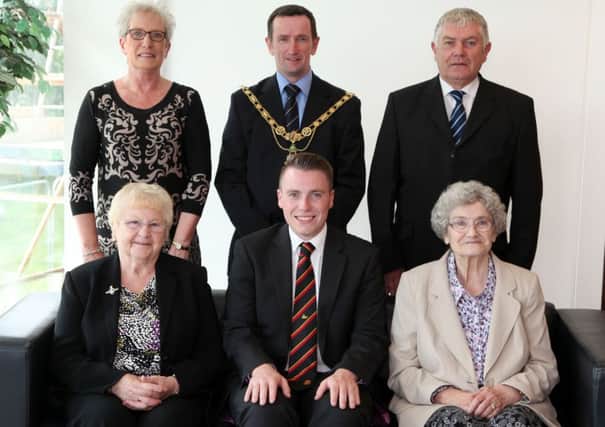 Adrian Craig, who has been awarded the points of light letter from the Prime Minister, is pictured during a reception at the Cloonavin last Tuesday. Included are seated; Tina Hanna and Kathleen Craig (both grandmothers). Standing are; William and Diane Craig (parents) and Councillor George Duddy, Mayor of Coleraine.
