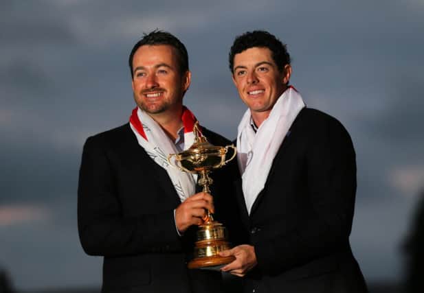 Graeme McDowell and Rory McIlroy celebrate with the Ryder Cup
 win. ©INPHO/Cathal Noonan