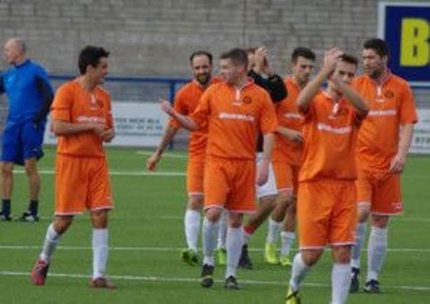 Carrick's players applaud the fans after Saturday's 3-0 win over Bangor in the Steel and Sons Cup. Photo: Adam Simpson