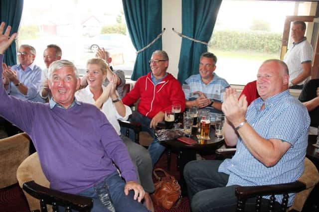 Patrons at Graeme McDowell's Rathmore Golf Club in Portrush celebrate Europe's Ryder Cup victory over the USA on Sunday. Graeme came from three down to beat Jordan Spieth. PICTURE MARK JAMIESON.