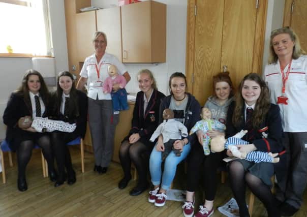 Red Cross teaching and practice of emergencies of children and babies to mums, partners and school pupils from Lisburn schools