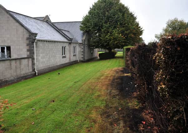 Hedge beside Moneymore Medical Centre that was 'deliberately' set alight by youths