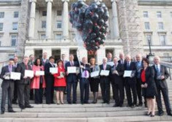 First Minister Peter Robinson joins MLAs on the steps of Parliament Buildings as 200 balloons were released to mark the launch of the website www.givinghopeni.com in support of Lord Morrow's Human Trafficking Bill