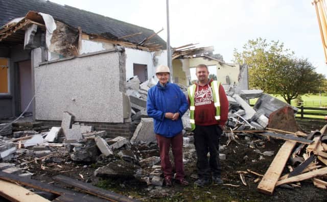 Frankie Heggarty (left) a member of Armoy Presbyterian Church and digger driver, Colin Smith, pictured during the demolition of the Church hall. INBM41-14S