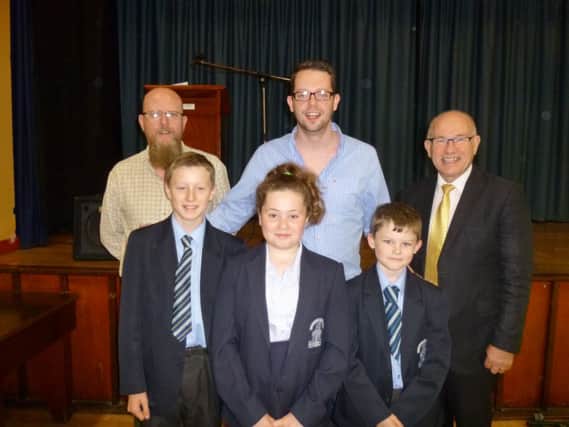 Past pupil, Craig Hutton, along with his dad Davy Hutton, Mr Wilkinson and Junior School Pupils.