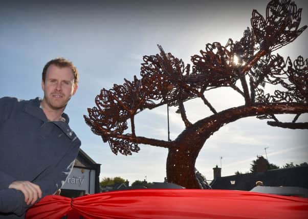 Artist Kevin Killen with his sculpture of a Hawthorne which was officially unveiled in Draperstown last Thursday morning.INMM4114-363