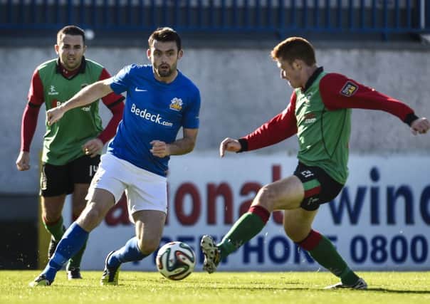Glenavon's Eoin Bradley and Glentoran's Kym Nelson in action at Mourneview Park.