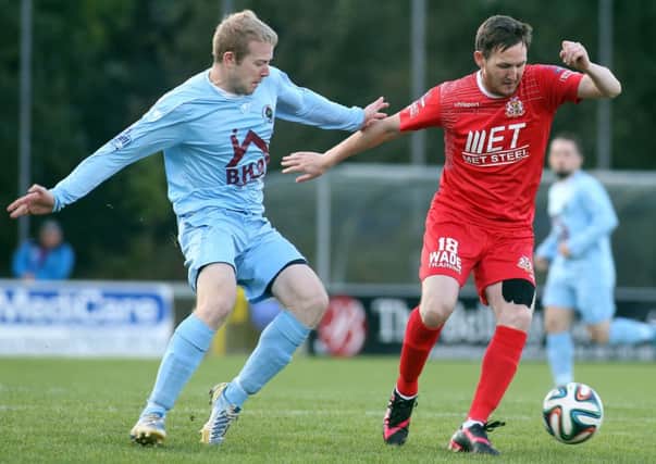 Portadown striker Gary Twigg shields the ball from Institute's Graham Crown, during Saturday's encounter at Drumahoe. Picture by Lorcan Doherty/Presseye.com