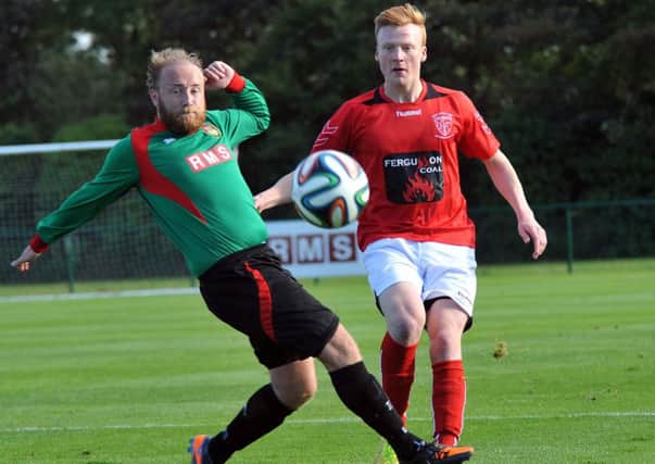 PSNI's Tyson Gray and Larne's Ross Davison pictured during Saturday's match at Newforge. Photo: Presseye