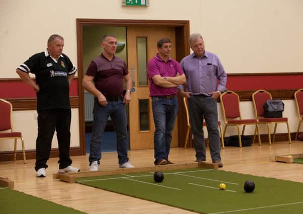 Connor and Second Broughshane 'B' bowlers examine the state of play during last week's match. Picture: Colin Turtle.