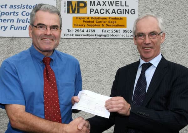Richard Wilson, treasurer of Ballymena Road Club, receives a sponsorship cheque from John Maxwell of Maxwell Packaging. INBT40-212AC