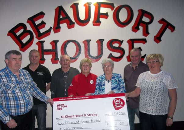 Mrs. Millar and family  present Valerie Saunders of the NI Chest Heart & Stroke with a cheque for £2,710.