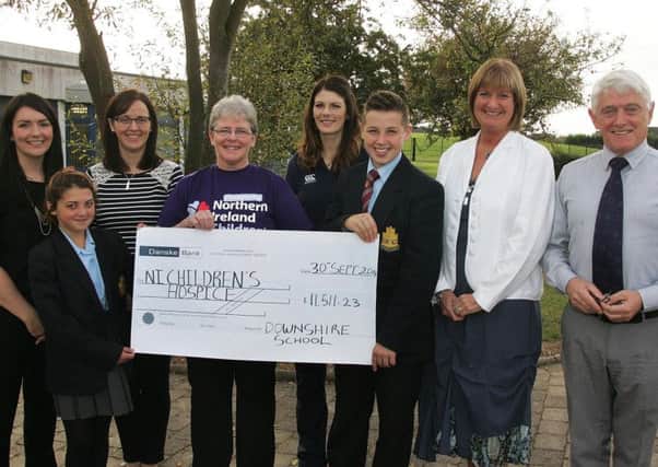 A cheque for £11,511.23 is presented by Downshire pupils Chelsea Campbell and Scott Black to Catherine OHara from Northern Ireland Children's Hospice. Included are principal Jacqueline Stewart (second from right) and teachers who took part in a fundraising canoe challenge,  Miss Wylie, Miss Aicken, Mrs Broadhurst and Mr Best. INCT 41-792-CON